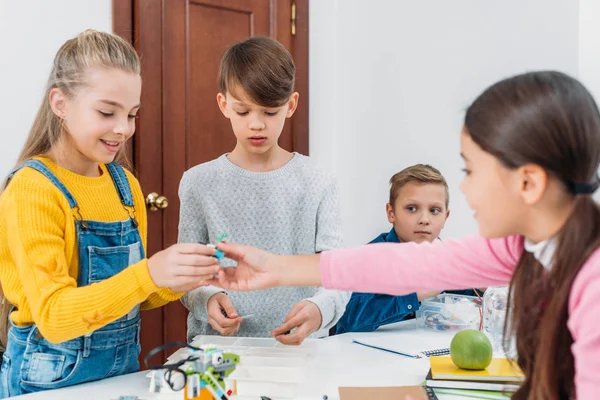 Schoolchildren working on robot programming at STEM class — Stock Photo