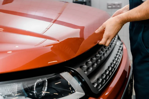 Cropped shot of auto mechanic opening car cowl for examination at mechanic shop — Stock Photo