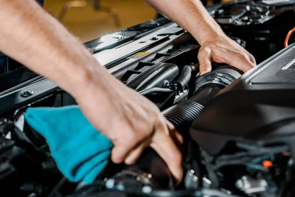 Cropped shot of auto mechanic with rag checking automobile — Stock Photo