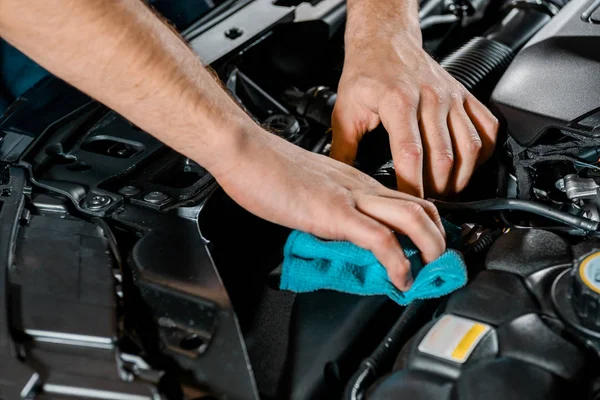 Cropped shot of auto mechanic with rag checking automobile — Stock Photo