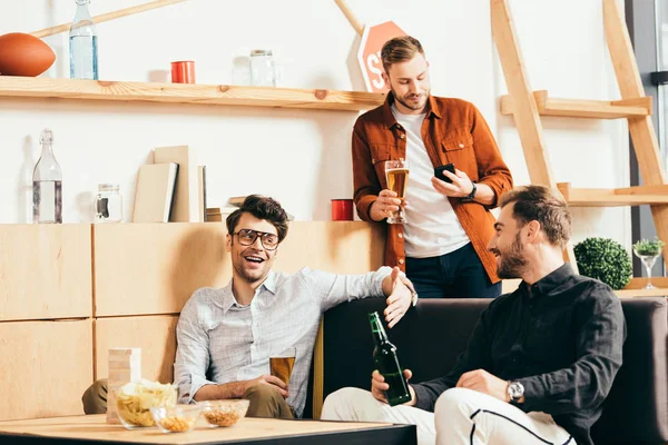 Friends with beer spending time together in cafe — Stock Photo