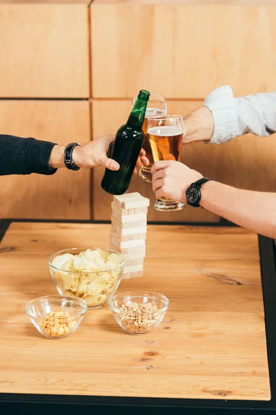 Partial view of friends clinking drinks while resting in cafe together — Stock Photo