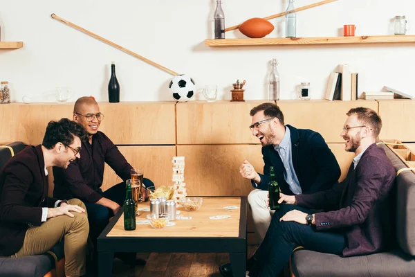 Cheerful multicultural business colleagues spending time together in cafe — Stock Photo