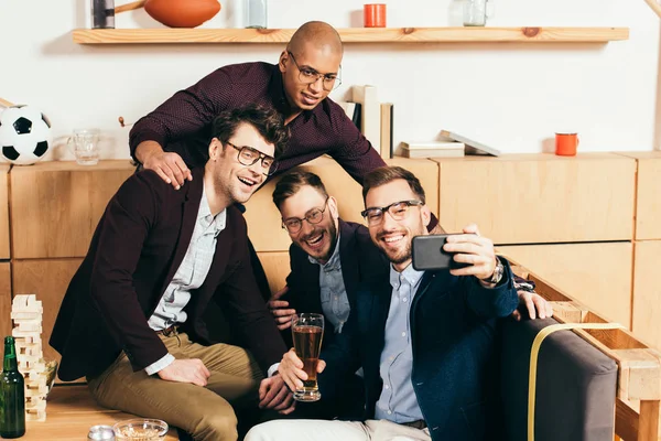Multiracial business colleagues taking selfie on smartphone while resting in cafe — Stock Photo
