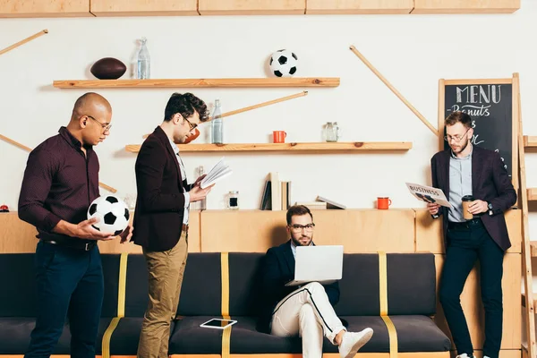 Group of multiracial young businessmen in cafe — Stock Photo