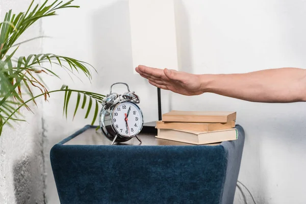 Cropped image of man turning off alarm clock in morning at home — Stock Photo