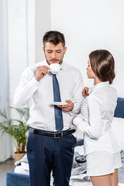 Girlfriend waiting while boyfriend drinking coffee in morning at home, social role concept — Stock Photo