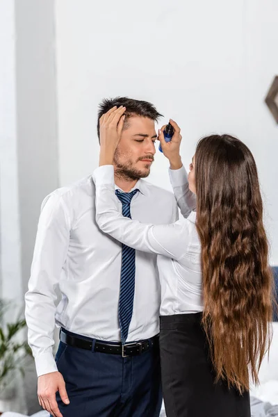 Girlfriend styling boyfriend hair in morning at home, social role concept — Stock Photo