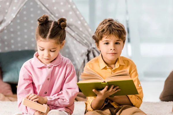 Adorable little children reading books together — Stock Photo