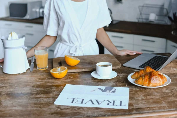 Cropped image of mixed race girl in white robe standing at table in morning in kitchen — Stock Photo