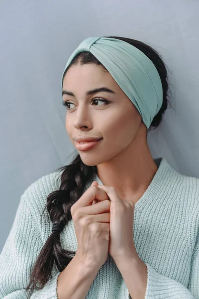 Schönes Mixed Race Girl in türkisfarbenem Pullover und Stirnband, das zu Hause wegschaut — Stockfoto