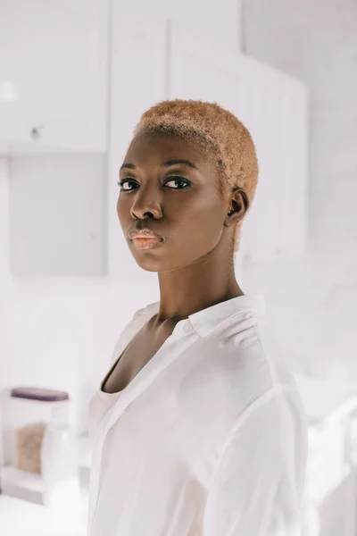 Selective focus of african american woman with short hair in pyjamas — Stock Photo