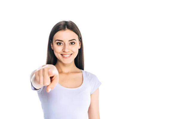 Portrait of smiling attractive woman pointing at camera isolated on white — Stock Photo
