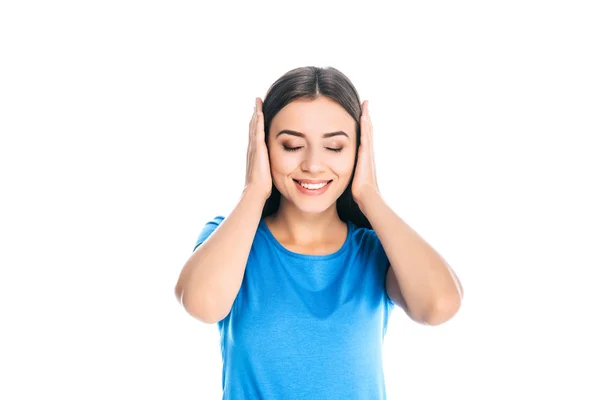 Portrait of attractive smiling woman covering ears with hands isolated on white — Stock Photo