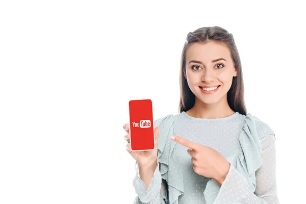 Smiling woman showing smartphone with youtube logo isolated on white — Stock Photo