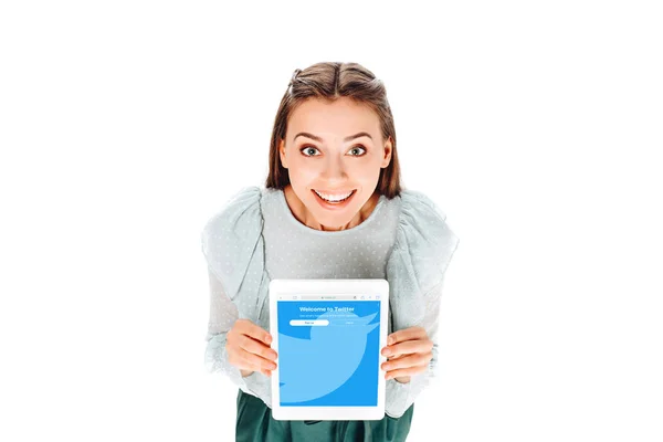 High angle view of cheerful woman with tablet with twitter logo on screen isolated on white — Stock Photo