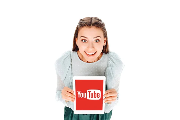 High angle view of smiling woman with tablet with youtube logo on screen isolated on white — Stock Photo