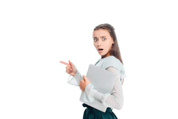 Side view of shocked woman with laptop pointing away isolated on white — Stock Photo