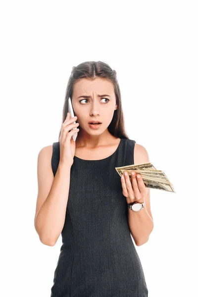 Portrait of emotional businesswoman with dollar banknotes talking on smartphone isolated on white — Stock Photo