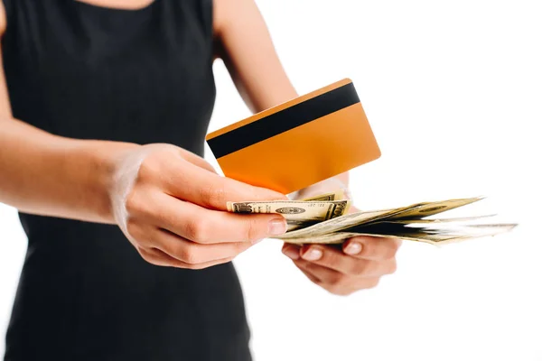 Partial view of woman in black dress with credit card and cash isolated on white — Stock Photo