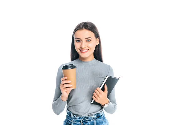 Portrait of smiling attractive woman with coffee to go and notebook isolated on white — Stock Photo