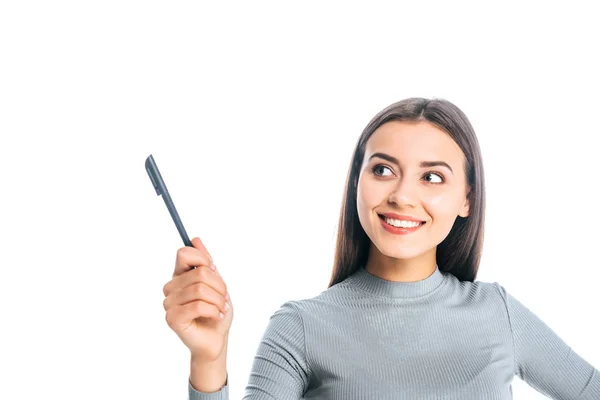 Portrait of smiling woman with pen pointing away isolated on white — Stock Photo