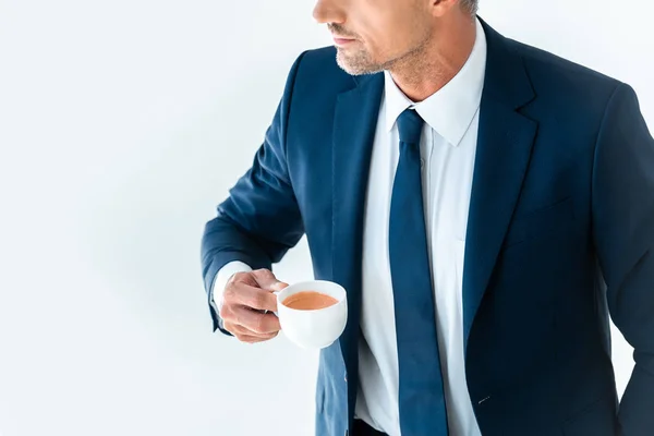 Cropped image of businessman holding cup of coffee isolated on white — Stock Photo