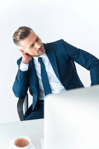 Tired handsome businessman touching neck isolated on white — Stock Photo