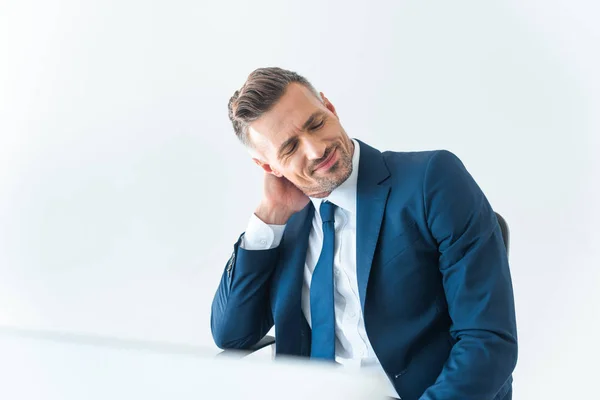 Alegre cansado empresário tocando pescoço isolado no branco — Fotografia de Stock