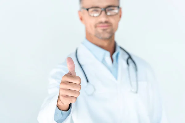 Selective focus of handsome doctor in glasses with stethoscope on shoulders showing thumb up isolated on white — Stock Photo