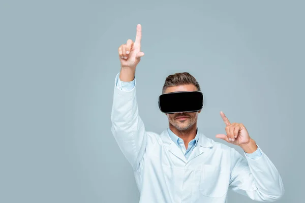 Scientist in virtual reality headset touching something isolated on grey, artificial intelligence concept — Stock Photo