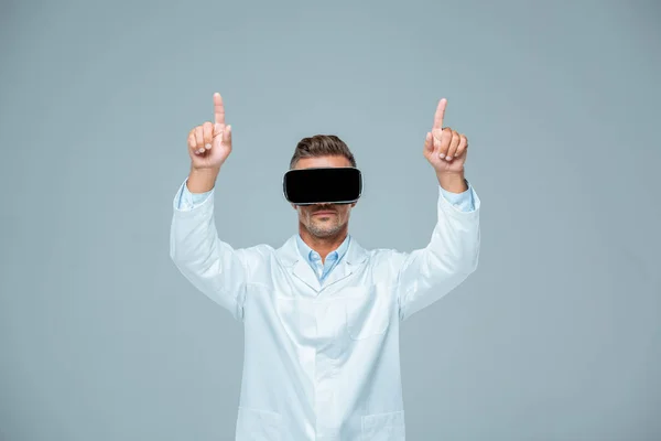 Scientist in virtual reality headset touching something with two fingers isolated on grey, artificial intelligence concept — Stock Photo