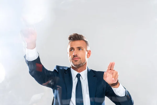 Handsome businessman touching something isolated on white, artificial intelligence concept — Stock Photo