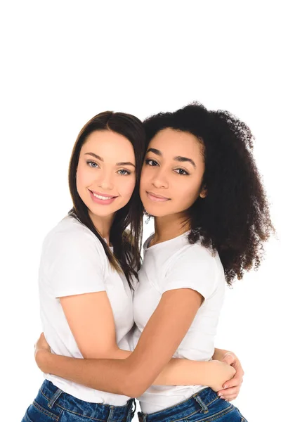 Multicultural friends hugging and looking at camera isolated on white — Stock Photo