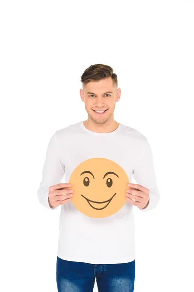 Schöner Mann mit runder gelber Karte und gerissenem Gesichtsausdruck auf weißem Hintergrund — Stockfoto