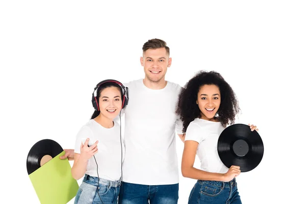 Multicultural young people hugging and holding vinyl records isolated on white — Stock Photo