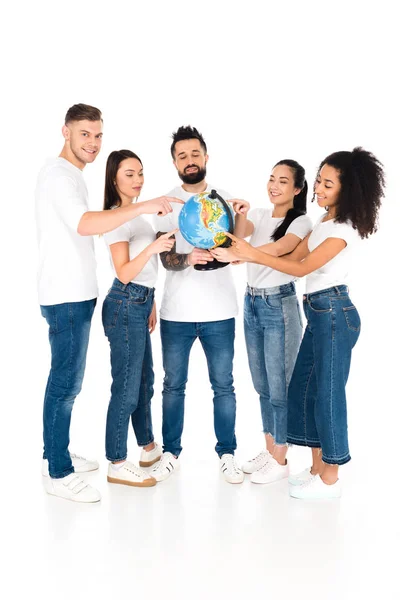 Multicultural group of young people pointing with fingers at globe isolated on white — Stock Photo