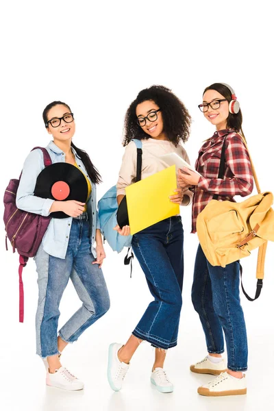 Attractive multicultural girls in glasses with vinyl records isolated on white — Stock Photo