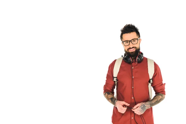 Cheerful man standing in glasses and headphones  isolated on white — Stock Photo