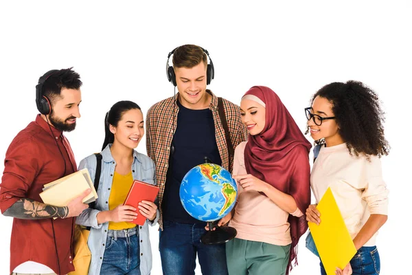 Cheerful muslim woman holding globe and standing with multicultural group of people isolated on white — Stock Photo