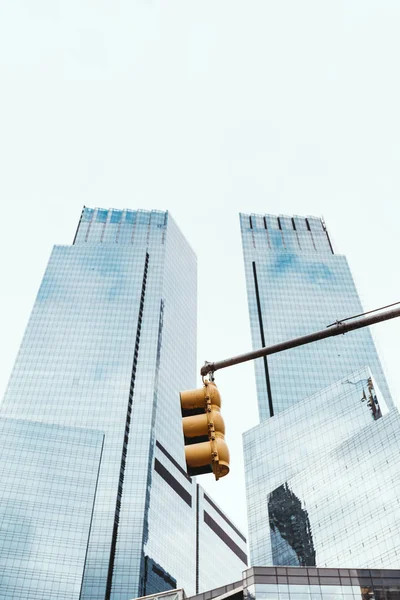 Low angle view of skyscrapers, traffic light and clear sky in new york city, usa — Stock Photo