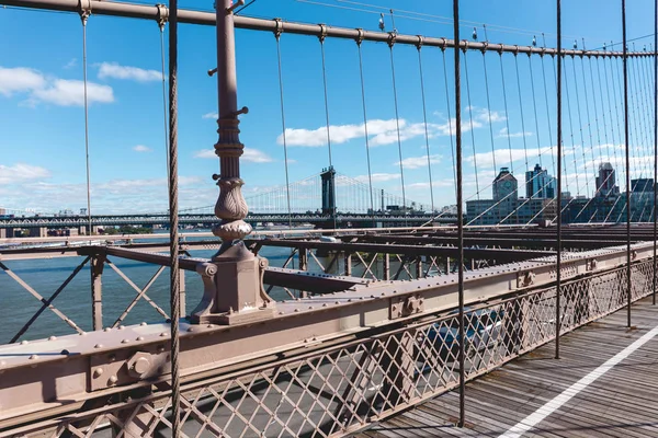Brooklyn bridge on blue sky and manhattan on background, new york, usa — Stock Photo