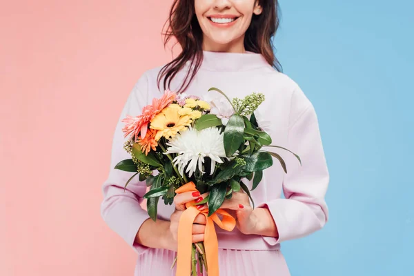 Обрізаний вид усміхненої жінки, що тримає квіти в руках на день щасливих матерів — стокове фото