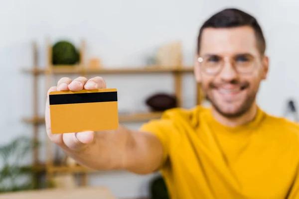 Foco seletivo do cartão de crédito na mão do homem feliz — Fotografia de Stock