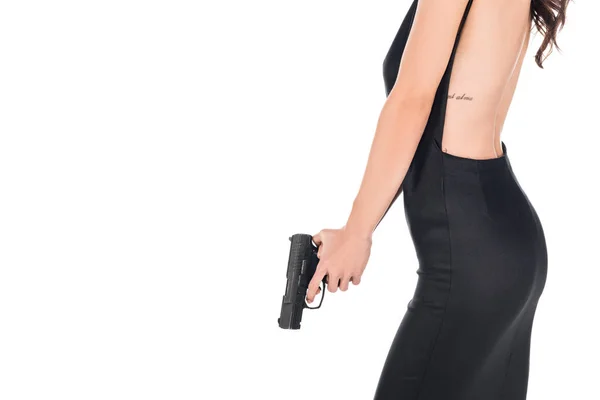 Cropped view of female killer in black dress holding gun, isolated on white — Stock Photo