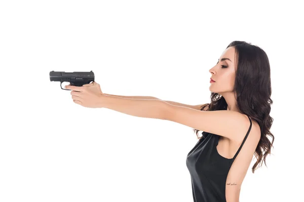 Beautiful female killer aiming with gun isolated on white — Stock Photo