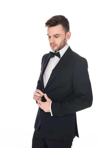 Handsome man posing in elegant black tuxedo and tie bow isolated on white — Stock Photo