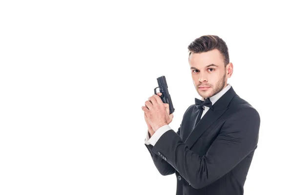 Bellissimo agente segreto in tuta nera con pistola, isolato su bianco — Foto stock