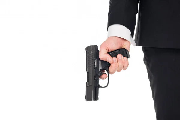 Vista parcial del agente secreto sosteniendo el arma, aislado en blanco — Stock Photo