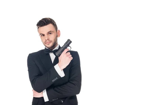 Serious secret agent in black suit holding handgun, isolated on white — Stock Photo